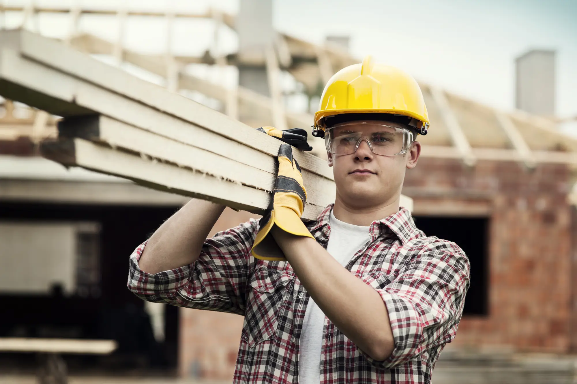 Roofer carrying materials